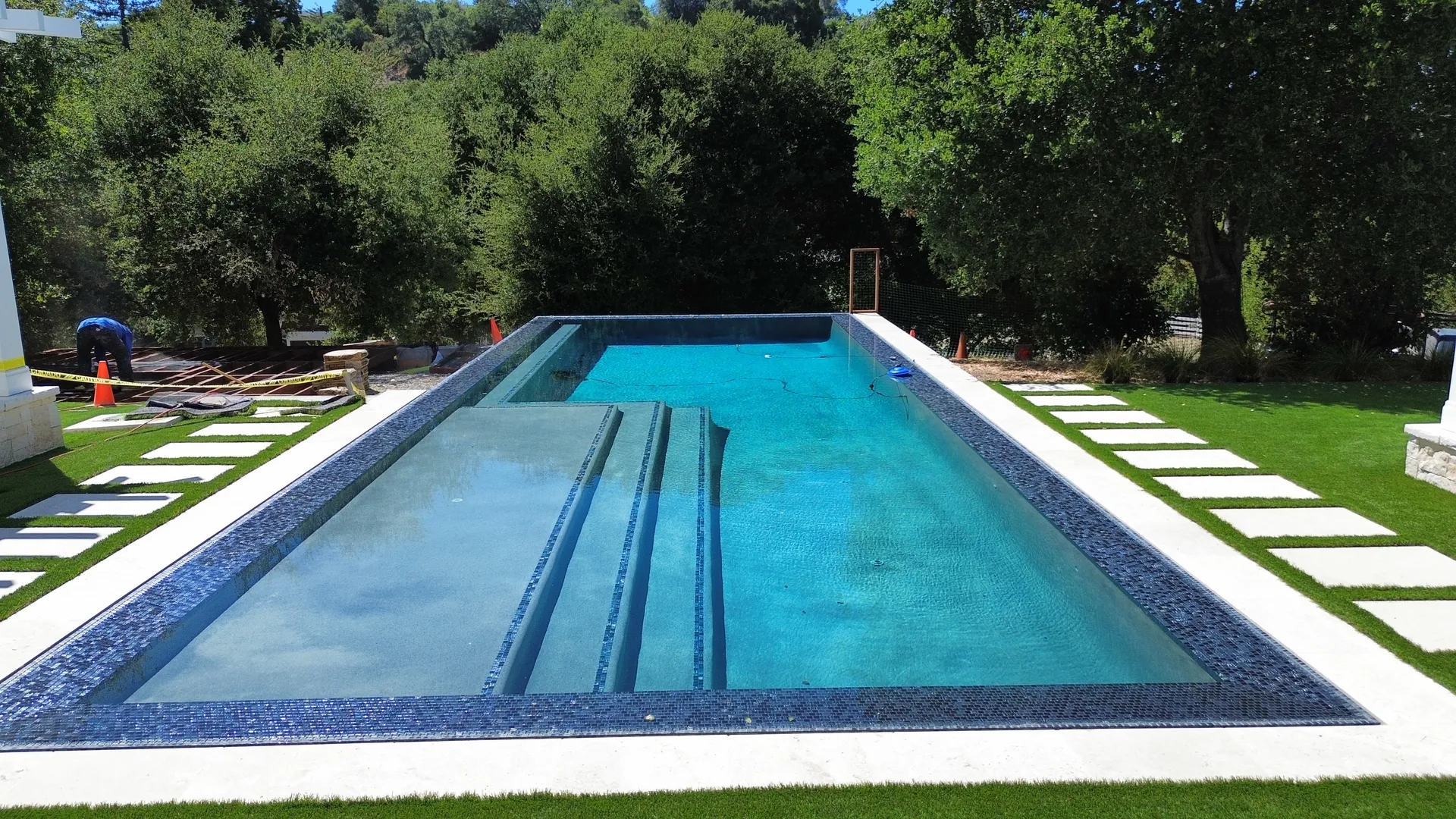 Aerial view of completed J Palace Construction custom home with pool, pergola, and full landscape design