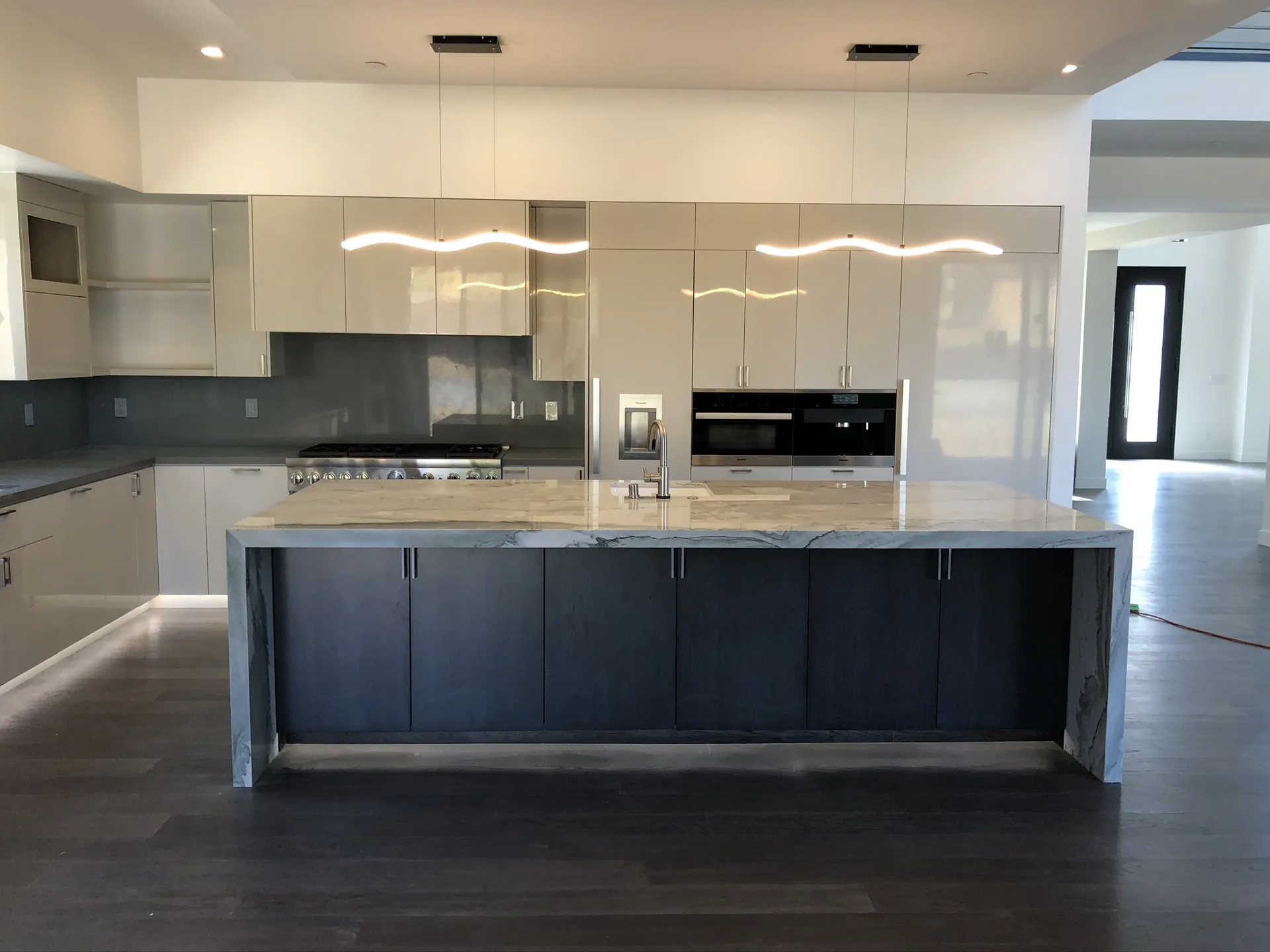Luxury kitchen remodel with marble waterfall island by J Palace Construction